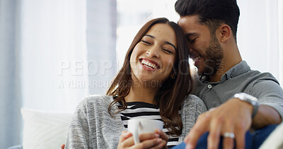 Buy stock photo Chilling, laughing and couple with coffee, home and love in living room with woman, hug and bonding. Happy, man and romance with partner in lounge, tea and comfortable in house, relax or relationship