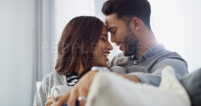 Buy stock photo Comfortable, laughing and couple with coffee, home and love in living room with woman, hug and bonding. Happy, man and forehead touch with partner in lounge, tea and chilling in house or relationship