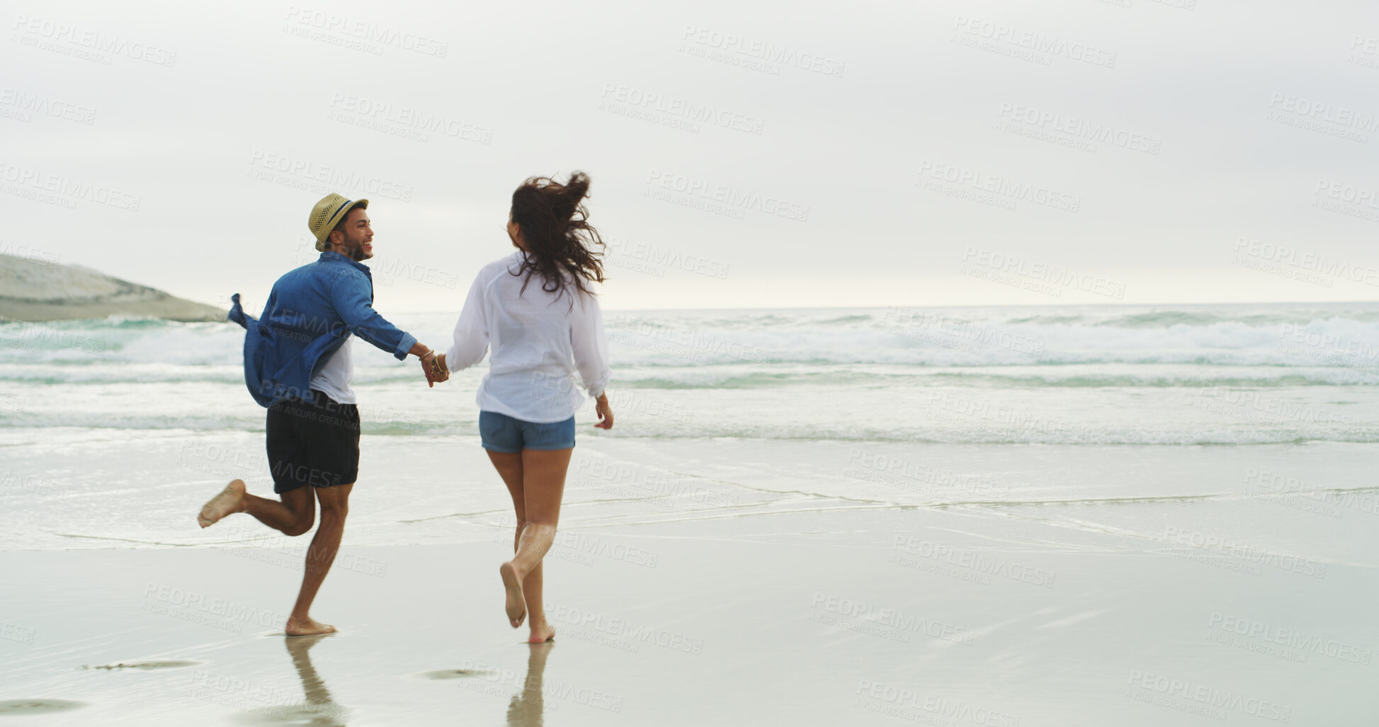 Buy stock photo Couple, beach and running on sand or holding hands on honeymoon, holiday or bonding outdoor. Woman, man and relationship by sea for fun memory, playful date and back with love and sunset space