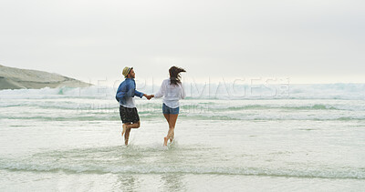 Buy stock photo Holding hands, beach and back of couple running on honeymoon, holiday or bonding outdoor. Woman, man and relationship by sea for fun memory, romantic date with love and trust on horizon space