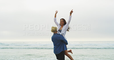 Buy stock photo Couple, beach and lift for fun on vacation with honeymoon, holiday or bonding outdoor in nature. Excited woman, man and freedom by sea for memory, playful date and happy with space and energy