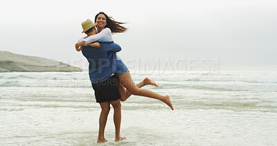 Buy stock photo Couple, lift and hug on beach for love, energy and bonding fun together with connection and anniversary travel. Playful, happiness and people embrace on ocean vacation space with commitment and care