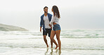 Happy couple, beach and walking together on vacation for honeymoon, holiday or bonding outdoor. Woman, man and relationship by sea for smile, romantic date and care with security in commitment 