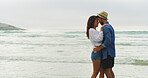 Couple, forehead and hug on beach for love, trust and bonding together with connection and anniversary travel. Peace, security and people embrace on sea vacation, commitment and care in relationship