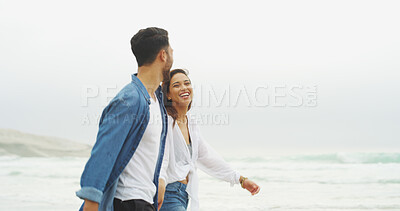 Buy stock photo Walking, happy couple and holding hands on beach for honeymoon, holiday or bonding outdoor. Woman, man and relationship by sea for memory, romantic date and laugh with love and fun stroll by space