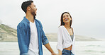 Beach, happy couple and laugh with love on holiday for honeymoon, vacation or bonding outdoor. Woman, man and relationship by sea for funny joke, romantic date and holding hands with playful partner