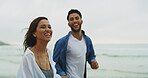 Beach, couple and laugh with holding hands on vacation, holiday and bonding together on honeymoon. Ocean, man and woman in portrait for love embrace, walking and travel adventure in Florida by space