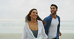 Beach, couple and smile with holding hands on vacation, holiday and bonding together on honeymoon. Ocean, man and woman with laugh for love embrace, walking and travel adventure in Florida by space