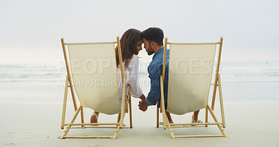 Buy stock photo Couple, beach and holding hands on vacation for honeymoon, holiday or bonding outdoor. Woman, man and relationship by sea for romantic date, chair and promise with forehead touch for connection