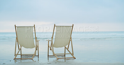 Buy stock photo Beach chairs, travel and space with water for relax, couple resort or tropical vacation. Ocean, wooden seats or sand with horizon for environment care, outdoor furniture or romantic holiday with view