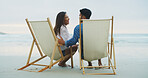Love, beach chair and couple laughing on vacation for honeymoon, holiday or bonding outdoor. Woman, man and relationship by sea for romantic date, funny joke and care with connection in nature
