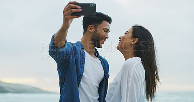 Buy stock photo Beach, couple and happy selfie with love on honeymoon, holiday or bonding outdoor. Woman, man and together by sea for memory, romantic date and content with laugh on social media for profile picture
