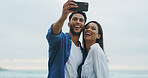 Beach, happy couple and selfie on vacation for honeymoon, laugh or picture outdoor in nature. Woman, man and social media post by sea for memory, romantic date and content with relationship goals