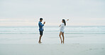 Beach, couple and photograph of woman for fun on honeymoon, holiday or bonding outdoor. Happy people, laugh and love by sea for memory, date and space with connection for social media profile picture