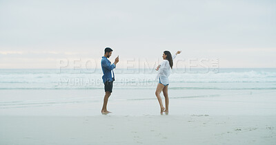 Buy stock photo Beach, couple and photograph of woman for fun on honeymoon, holiday or bonding outdoor. Happy people, laugh and love by sea for memory, date and space with connection for social media profile picture