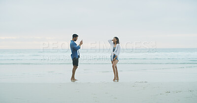 Buy stock photo Happy couple, beach and photograph of woman on vacation, holiday or bonding outdoor. People, honeymoon and love by sea for memory, date or space with connection for social media profile picture