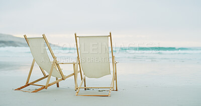 Buy stock photo Beach chairs, travel and space with waves for relax, couple resort or tropical vacation. Ocean, wooden seats or sand with horizon for environment care, outdoor furniture or romantic holiday with view