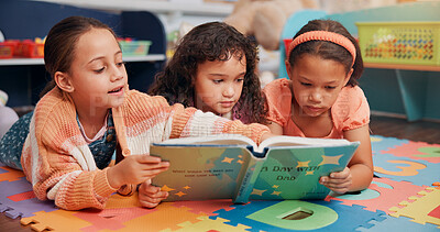Buy stock photo Reading book, girls and friends on carpet, school and learning with education, break and bonding together. Group, storytelling and children in classroom, literacy knowledge and kids with fantasy