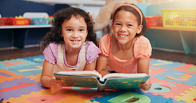 Buy stock photo Children, girl and portrait on floor with reading book, learning and smile together for education in classroom. School kids, happy and friends with literature, development and scholarship at academy