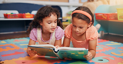 Buy stock photo Girls, reading book and friends on ground, school and learning with education, growth and literacy knowledge. Group, storytelling and kids in classroom, child development and children with break