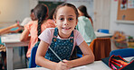 Writing, student and education with girl in classroom for learning, future and youth. Scholarship, academy and growth with portrait of kid in school for child development, knowledge and lesson