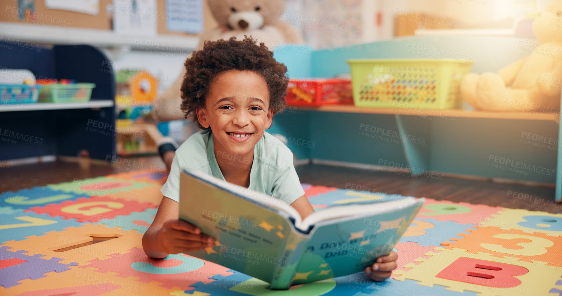 Buy stock photo Boy, reading book and portrait on floor in home for development, story and knowledge in morning. Child, learning and study in bedroom at family house, smile and education with literature in Kenya
