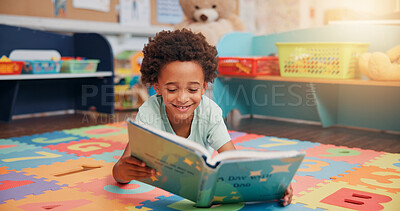 Buy stock photo African boy, reading book and floor in classroom for development, storytelling and knowledge at academy. Child, learning and study for scholarship, smile or info with course at elementary school