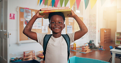 Buy stock photo Boy, portrait and books on head at school, smile and excited for education, story or development. African child, happy and learning in classroom, start and reading for scholarship at academy in Kenya