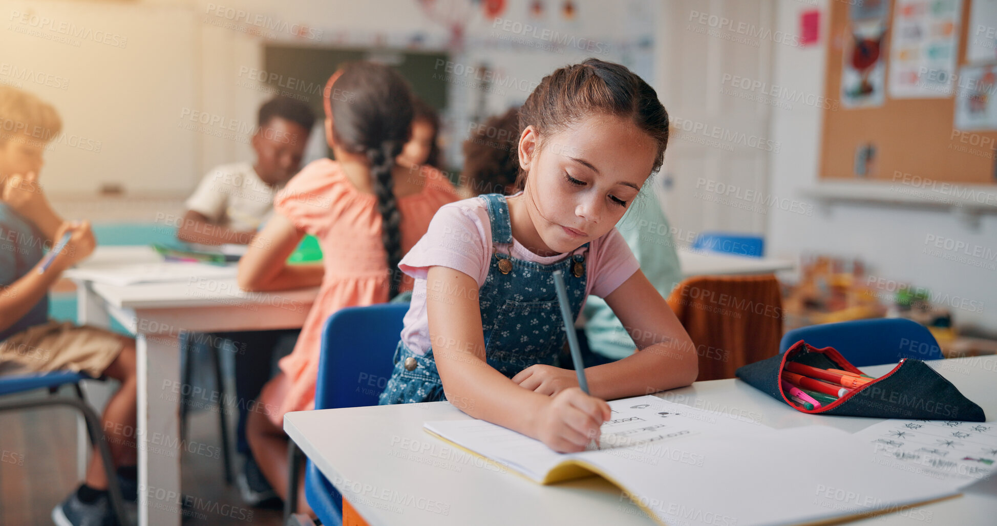 Buy stock photo Writing, student and learning with girl in classroom for education, future and youth. Scholarship, academy and growth with kid and notebook in school for child development, knowledge and lesson
