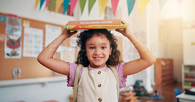 Buy stock photo Girl, portrait and books on head in classroom, smile and excited for education, story or development. Child, happy and learning at academy, start and scholarship with backpack at school in Mexico