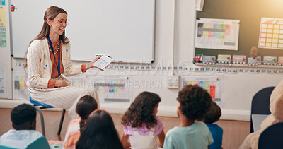 Buy stock photo Teacher, kids and card in classroom with question, smile and quiz with education at academy. Woman, children and assessment with language, happy and development with learning at elementary school