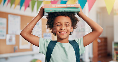 Buy stock photo Boy, smile and books on head in classroom, portrait and excited for education, story or development. African child, happy and learning at academy, start and reading for scholarship at school in Kenya