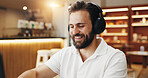 Remote work, cafe and business man with headphones listening to podcast for online project, report and proposal. Coffee shop, freelancer and person on laptop for streaming music, website and research