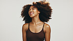 Smile, hair and shake with woman in studio for volume, natural texture and beauty. Happiness, self care and cosmetics with African person on white background for growth, shampoo and salon treatment