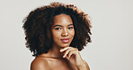 Portrait, afro or African woman in studio for hair care, texture or glow for volume or natural shampoo. Proud, face or model with beauty, smile or growth for cosmetics or results by white background