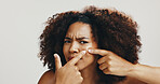Portrait, African woman and skincare for acne, checking and skin breakout on white studio background. Squeeze, model and person with cosmetics, blemish and spa treatment for natural beauty aesthetic