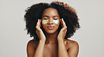 Eye patches, skincare and woman in studio for wellness, anti aging and facial treatment. Dermatology, spa and face of African person with pads for collagen, beauty and cosmetics on white background