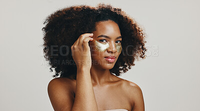 Buy stock photo Eye mask, skincare and portrait of woman in studio for wellness, anti aging and facial. Dermatology, spa and face of African person with patches for collagen, beauty and cosmetics on white background