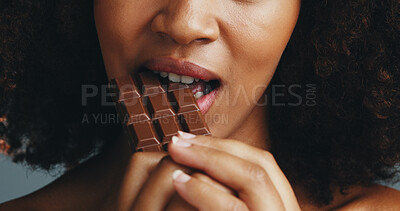 Buy stock photo Studio, bite and person with chocolate, closeup and hands with delicious snack, dessert and eating. Mouth, taste and food with serotonin for woman, sugar or candy with health benefits of antioxidants