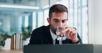 Businessman, water or drink with laptop for hydration, thirst or thinking at office desk. Man, employee or mineral liquid on computer for natural sustainability, relief or healthy living at workplace