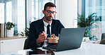 Business, man and laptop with eating salad in office for working lunch, reading economic trends or online report. Financial analyst, person or healthy food at desk with technology for market research
