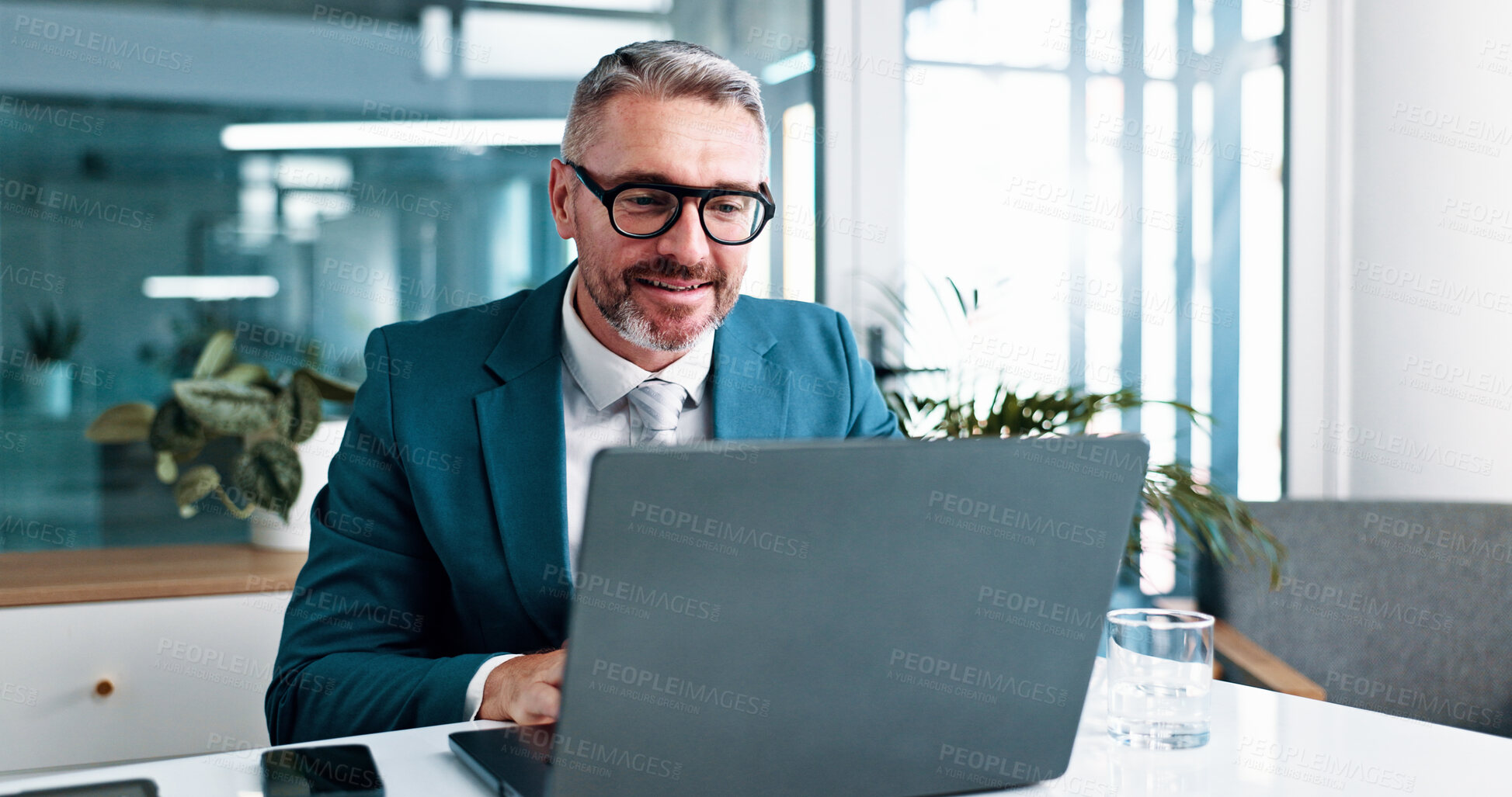 Buy stock photo Mature, businessman and reading with laptop in office, financial report and auditing for corporate firm. Career, male person and accountant with tech for investment research, administration and smile