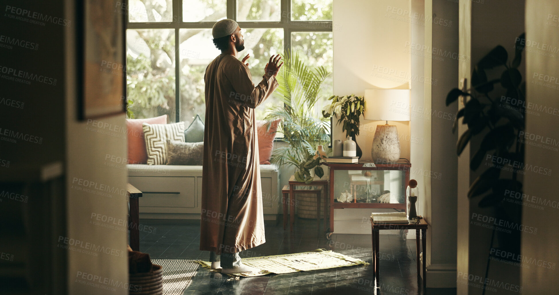 Buy stock photo Islamic, man and praying to god at house for spiritual worship, praise Allah and Ramadan belief. Muslim, person and holy dua for forgiveness, mindfulness and fasting tradition with religion guidance 