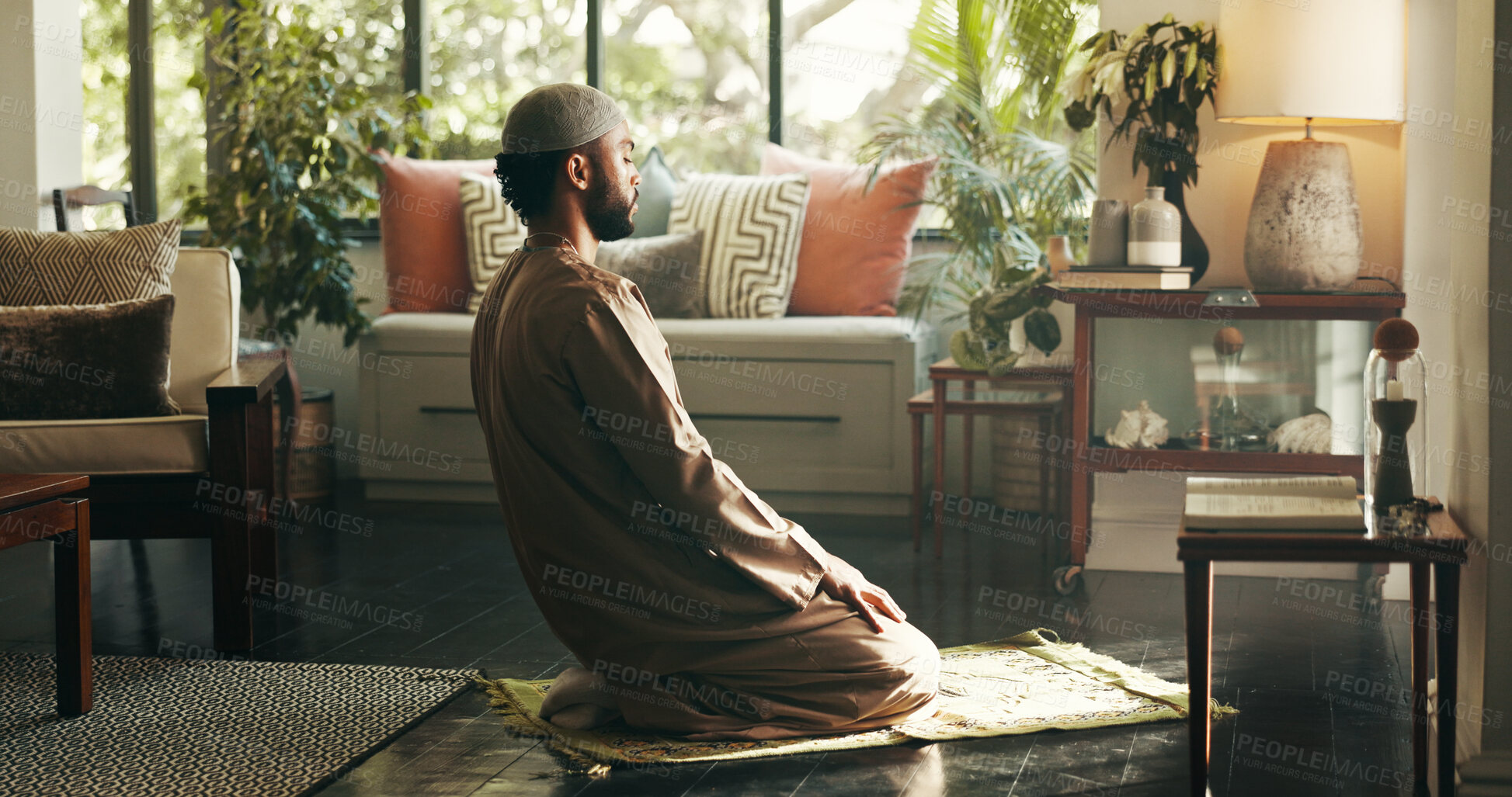 Buy stock photo Muslim, man and praying to god at house for spiritual worship, praise Allah and Ramadan belief. Person, kneeling and dua for forgiveness, mindfulness and fasting tradition with guidance of protection