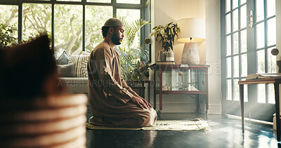 Buy stock photo Islam, prayer and religion with man in home for ramadan kareem, spiritual and worship. Floor, faith and eid Mubarak with Muslim person and salah in living room for holy month, Allah praise and dua