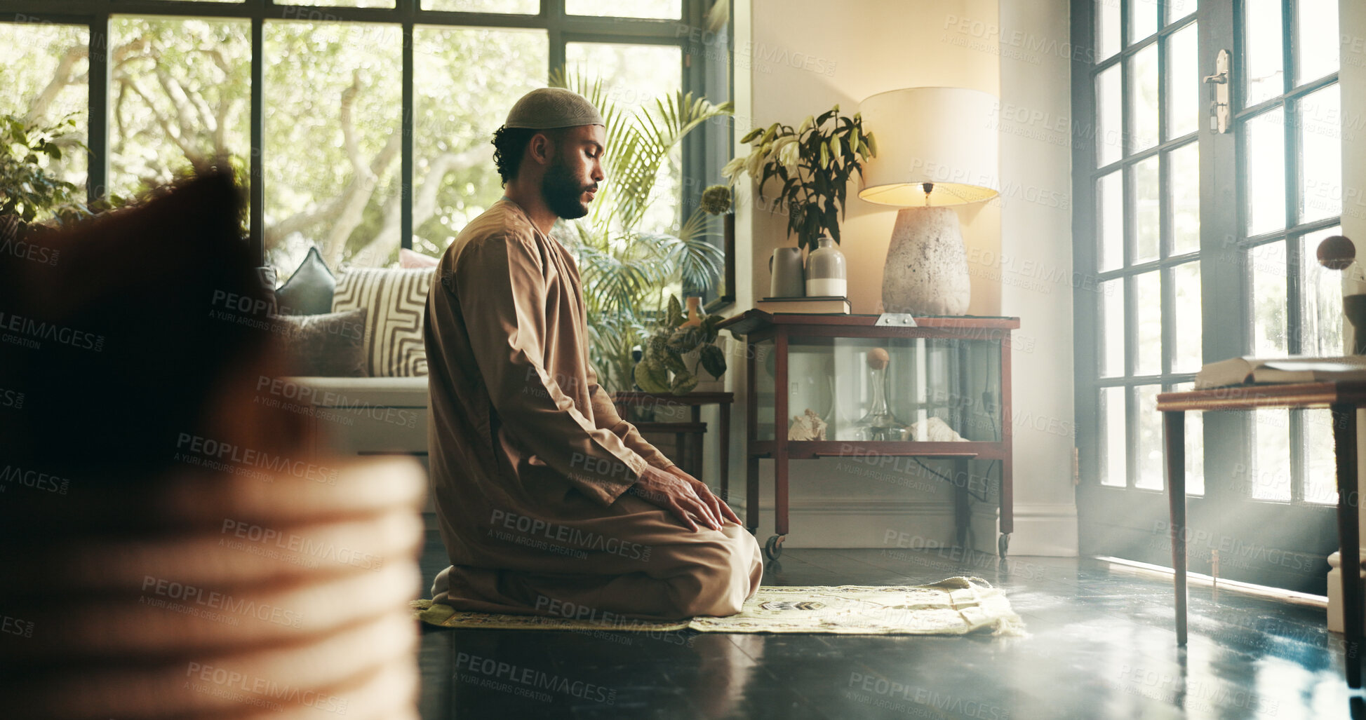 Buy stock photo Islam, prayer and religion with man in home for ramadan kareem, spiritual and worship. Floor, faith and eid Mubarak with Muslim person and salah in living room for holy month, Allah praise and dua