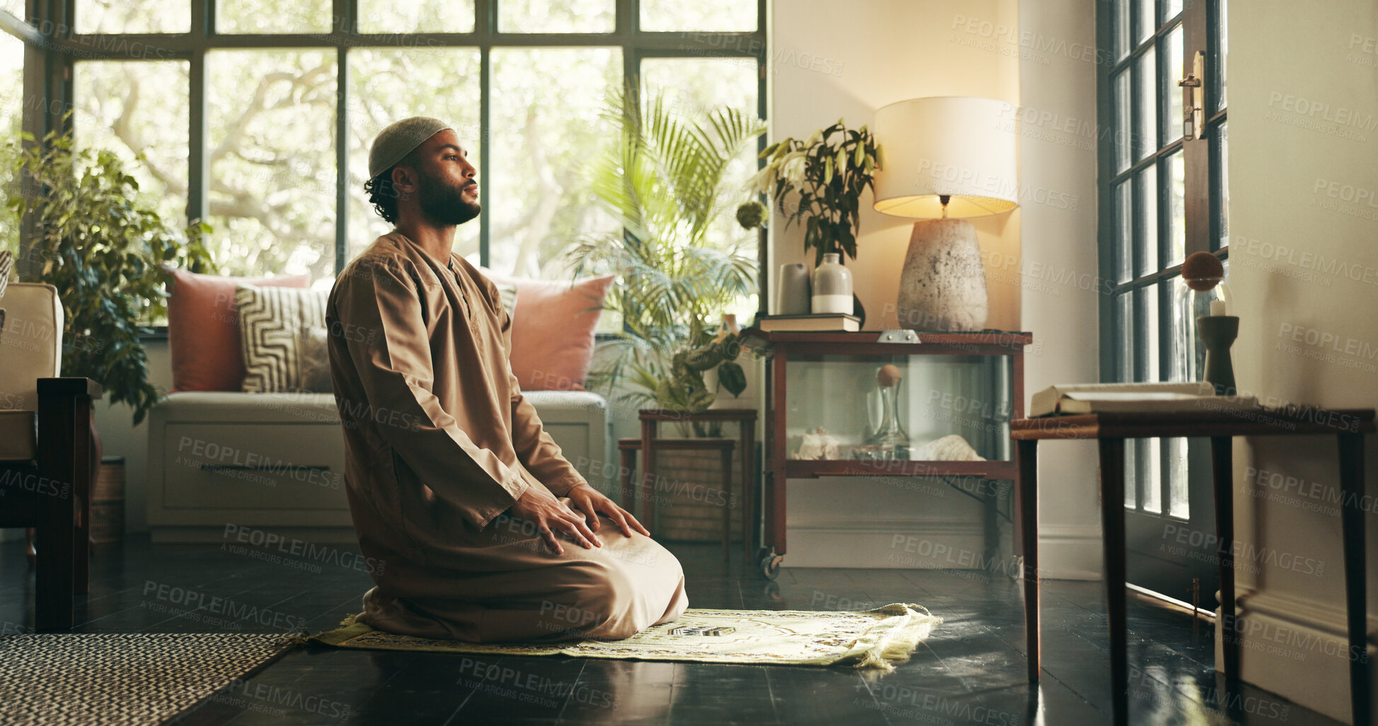 Buy stock photo Muslim, man and praying with faith at house for spiritual worship, praise Allah and belief in Ramadhan. Male person, prayer and dua in salah, forgiveness and mindfulness of fasting tradition in Islam