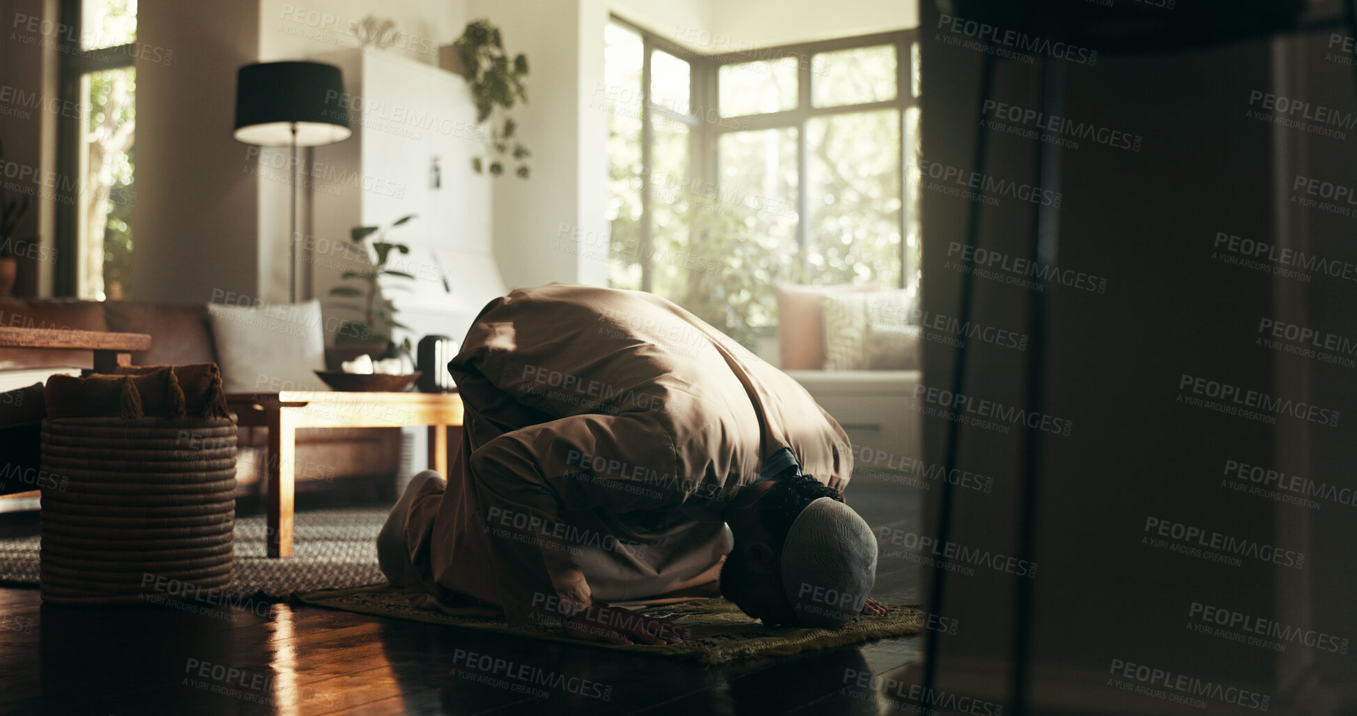 Buy stock photo Islam, worship and religion with man at home for ramadan kareem, spiritual and prayer. Floor, faith and eid Mubarak with Muslim person and salah in living room for gratitude, Allah praise and dua