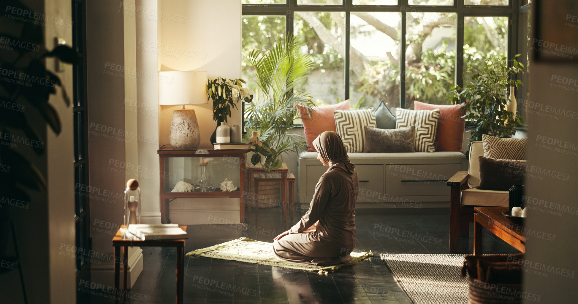 Buy stock photo Muslim woman, praying and mat in home for faith, Islam or relationship with Allah in morning. Person, hijab and back for Ramadan, religion and trust in God for fasting, dua or reflection at apartment