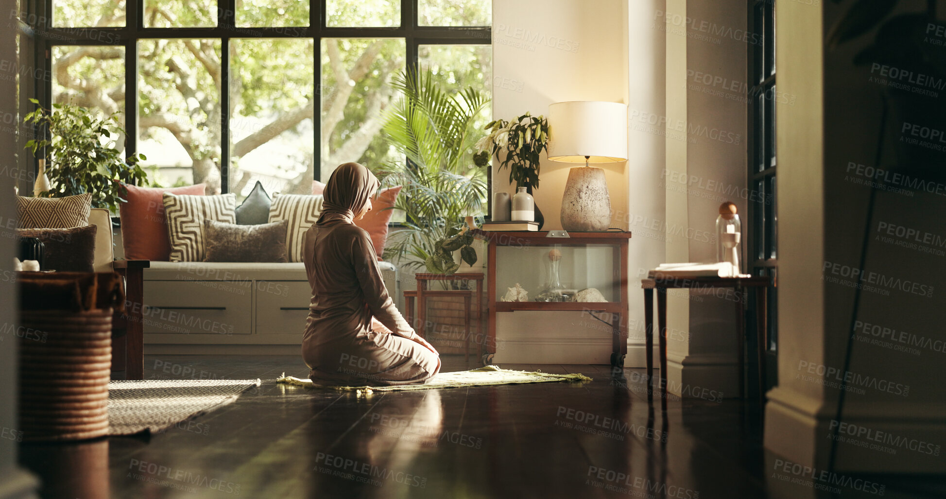 Buy stock photo Muslim woman, praying and floor in home, Islam or kneeling for relationship with Allah in morning. Person, hijab and back for Ramadan, mat and religion for God for fasting, dua or reflection at house